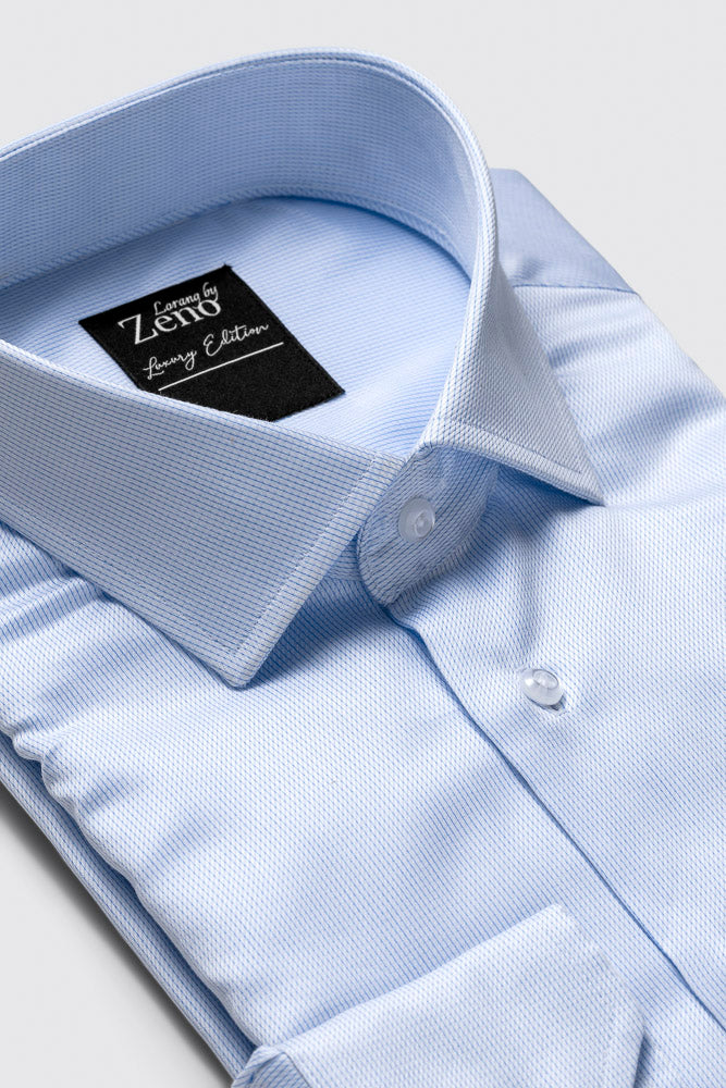 Stoff og sømdetaljer på brettet lys blå dresskjorte med mini hundetannsmønster. Cut away-snipp og lyse og elegante knapper. Foto 